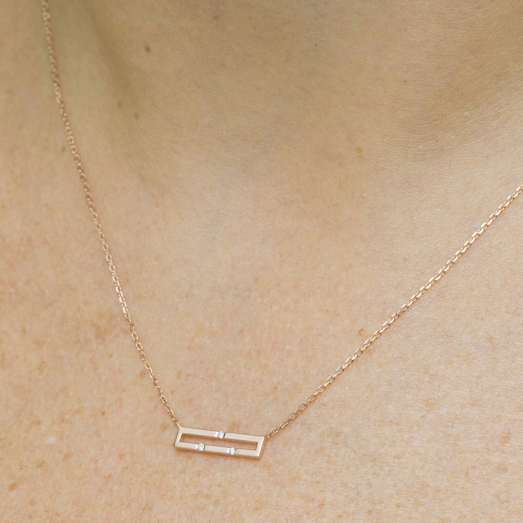 Versa Mini 18K rose gold diamond necklace worn on neckline