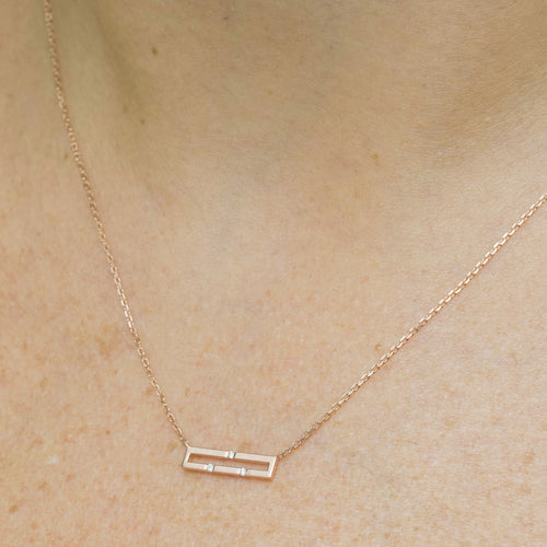 Versa Mini 18K rose gold diamond necklace worn on neckline
