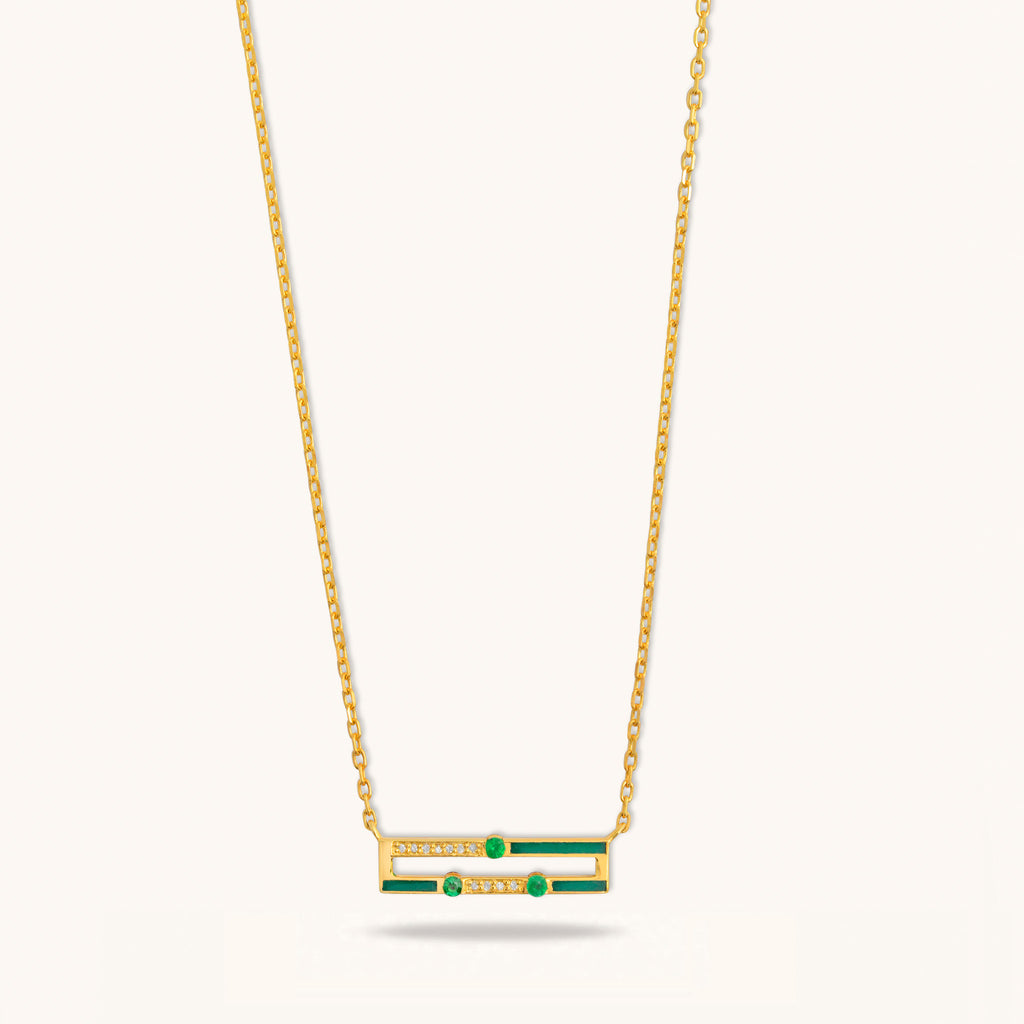 Front view of Versa mini emerald necklace showing green enamel, diamonds, and emerald stones in 18K gold