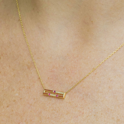 Worn view of Versa mini emerald and ruby reversible necklace in 18K gold with diamonds and enamel